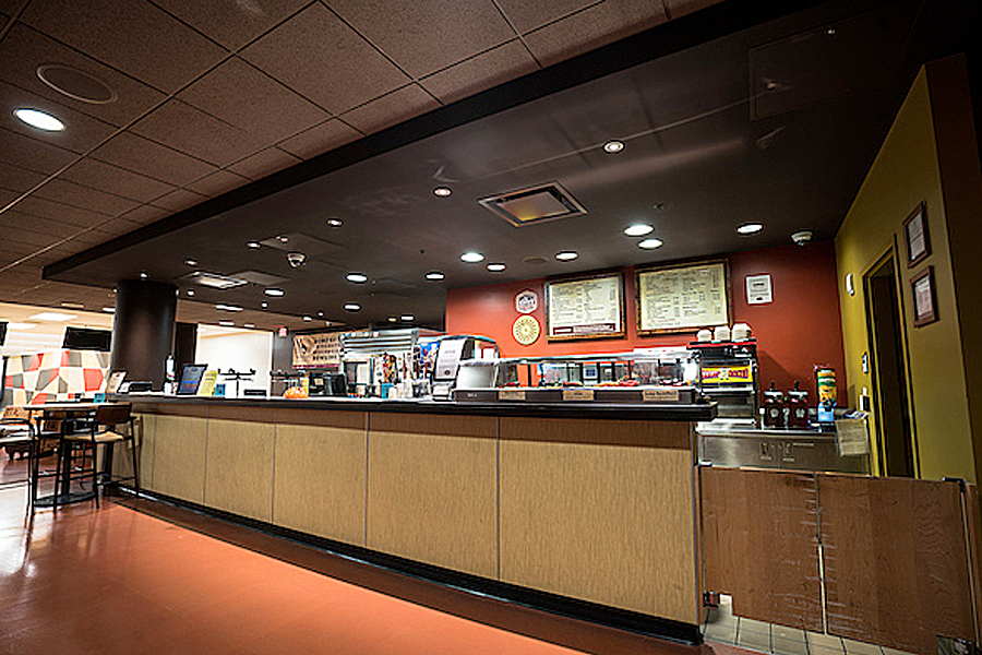 Wood paneled bowling and games rental counter at The Sett Recreation.