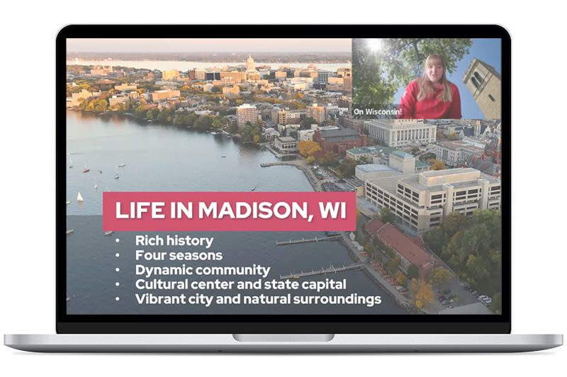 Laptop screen displaying a slide titled Life in Madison, WI over an aerial view of the city, with a bullet list and a small video window showing a person speaking.